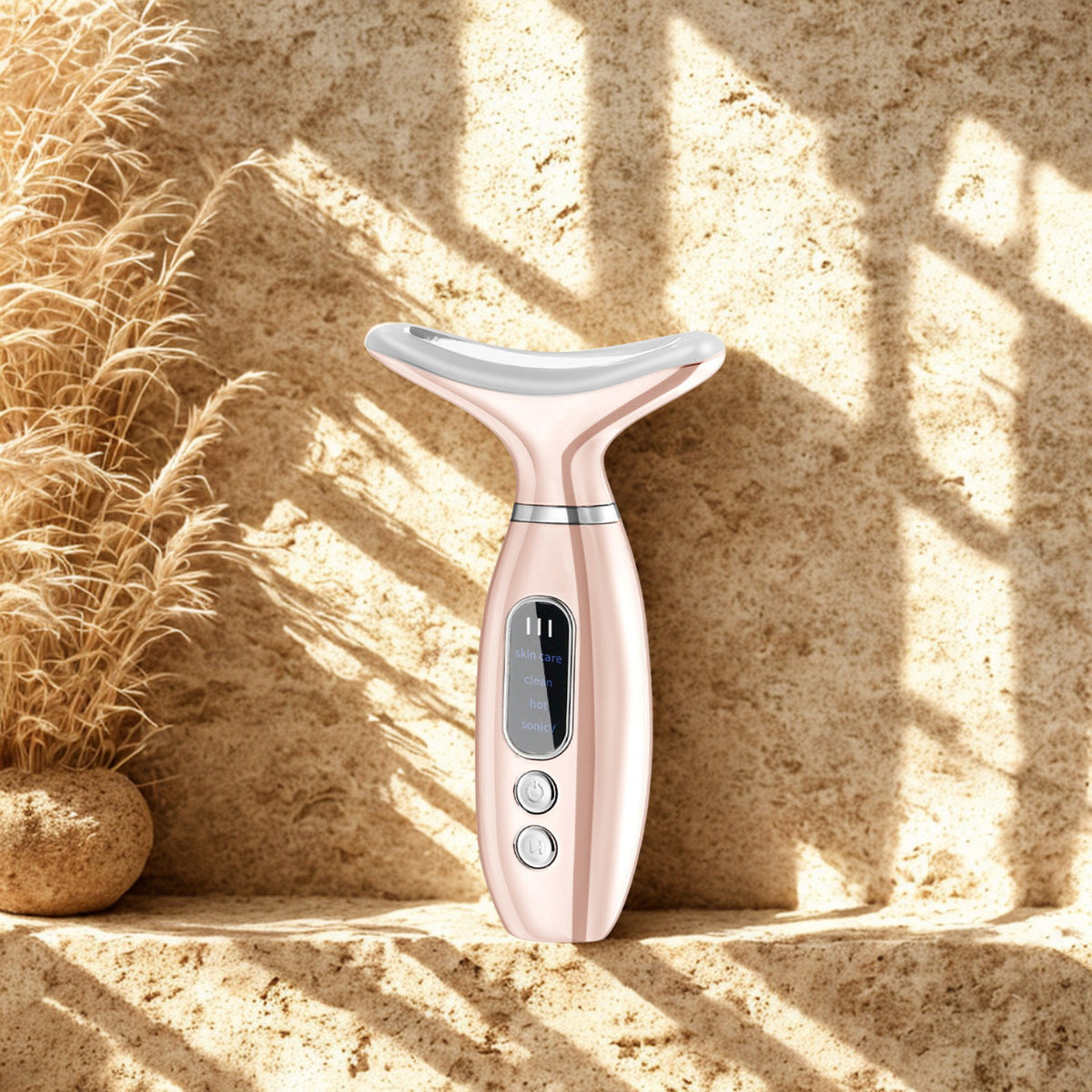 Heated Neck & Face Massager on a travertine ledge in warm window light