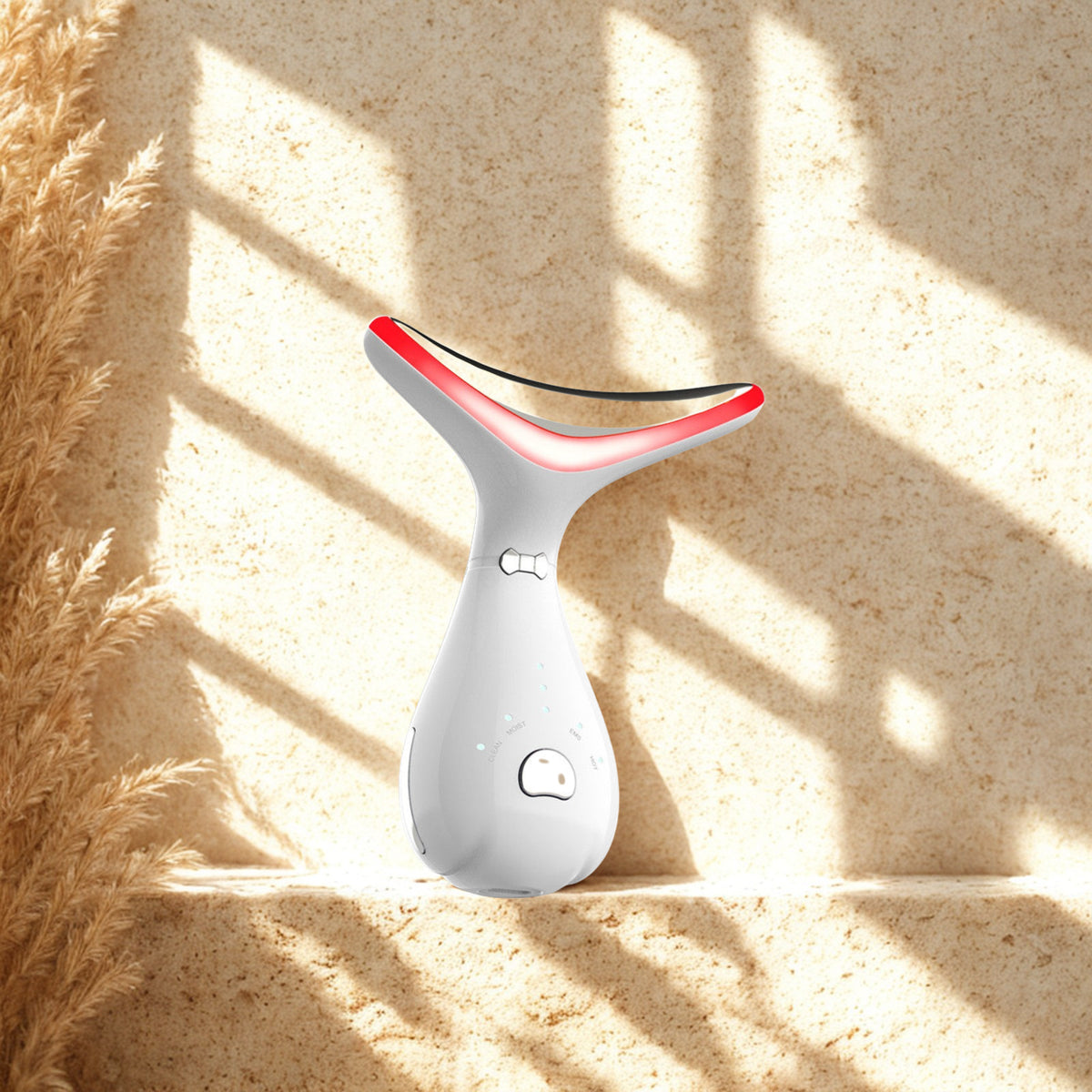 LED Neck Massage Device on a travertine ledge in warm window light