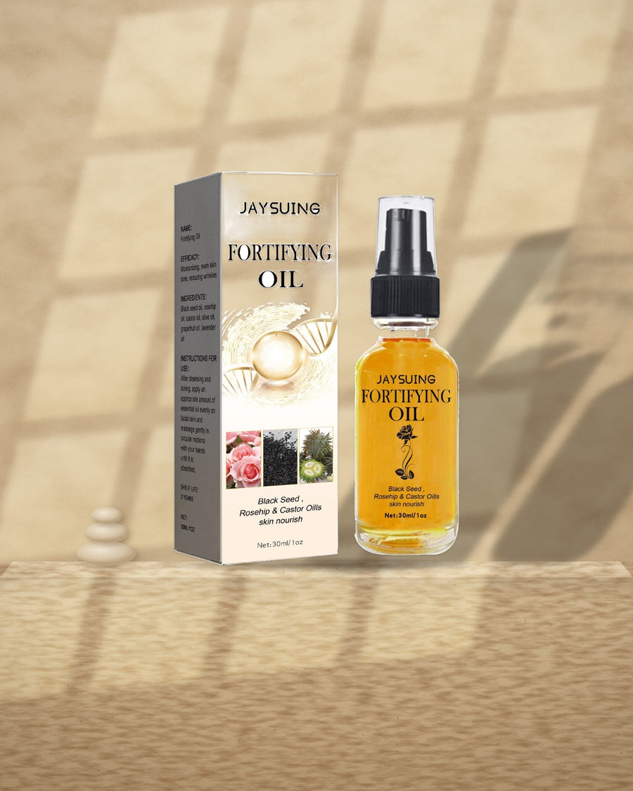 Black Seed, Rosehip & Castor Facial Oil on a travertine ledge in window light