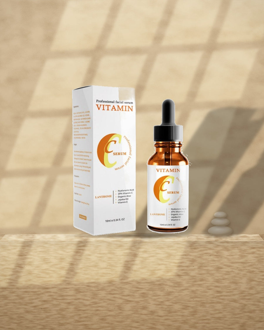 Vitamin C & Hyaluronic Acid Serum on a travertine ledge in window light