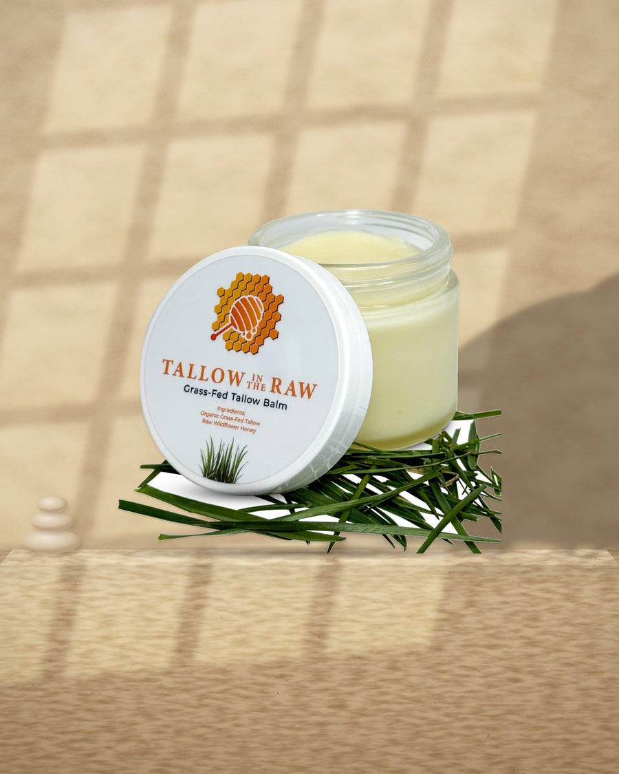 Tallow & Honey Balm on a travertine ledge in window light